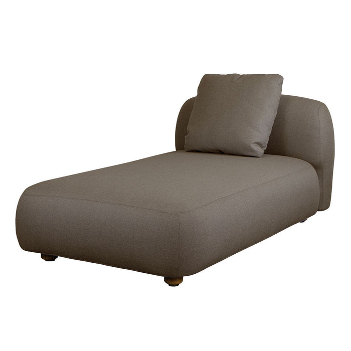 Brown upholstered chaise lounge with a smooth finish and modern curved design, complemented by a matching plush pillow.