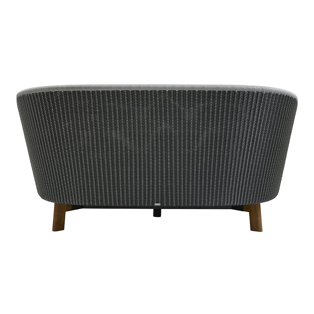 Gray and white checkered pattern on a curved sofa with wooden legs. Back view showcasing modern design.