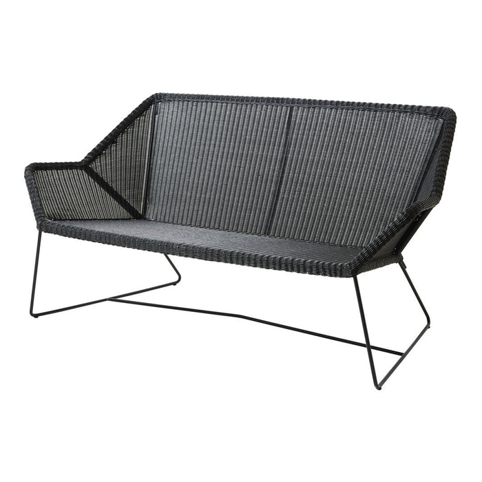 Modern black wicker sofa with geometric pattern and sleek metal legs, perfect for contemporary outdoor spaces.