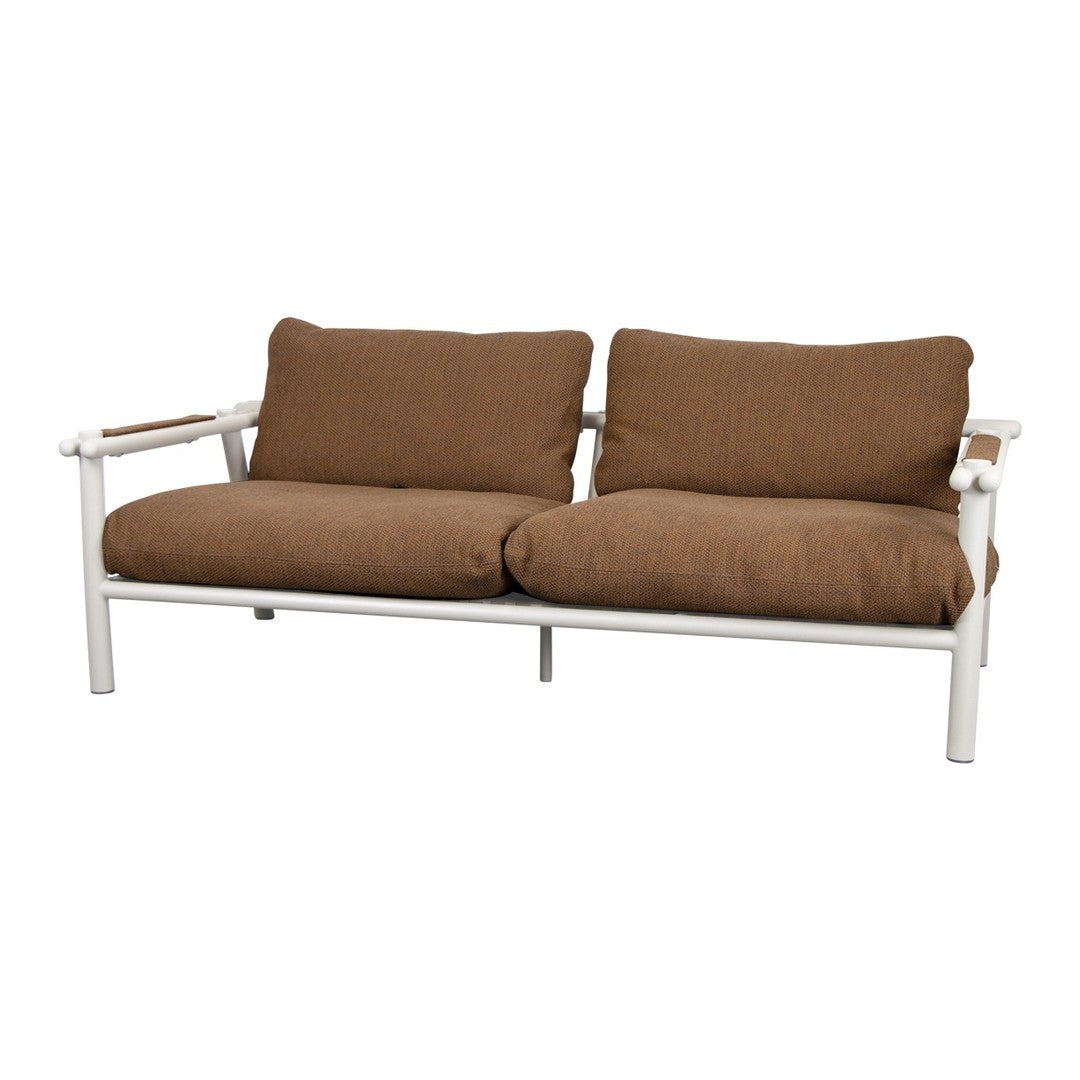 Brown cushioned sofa with a sleek white frame and natural wood accents, perfect for modern outdoor or indoor decor.