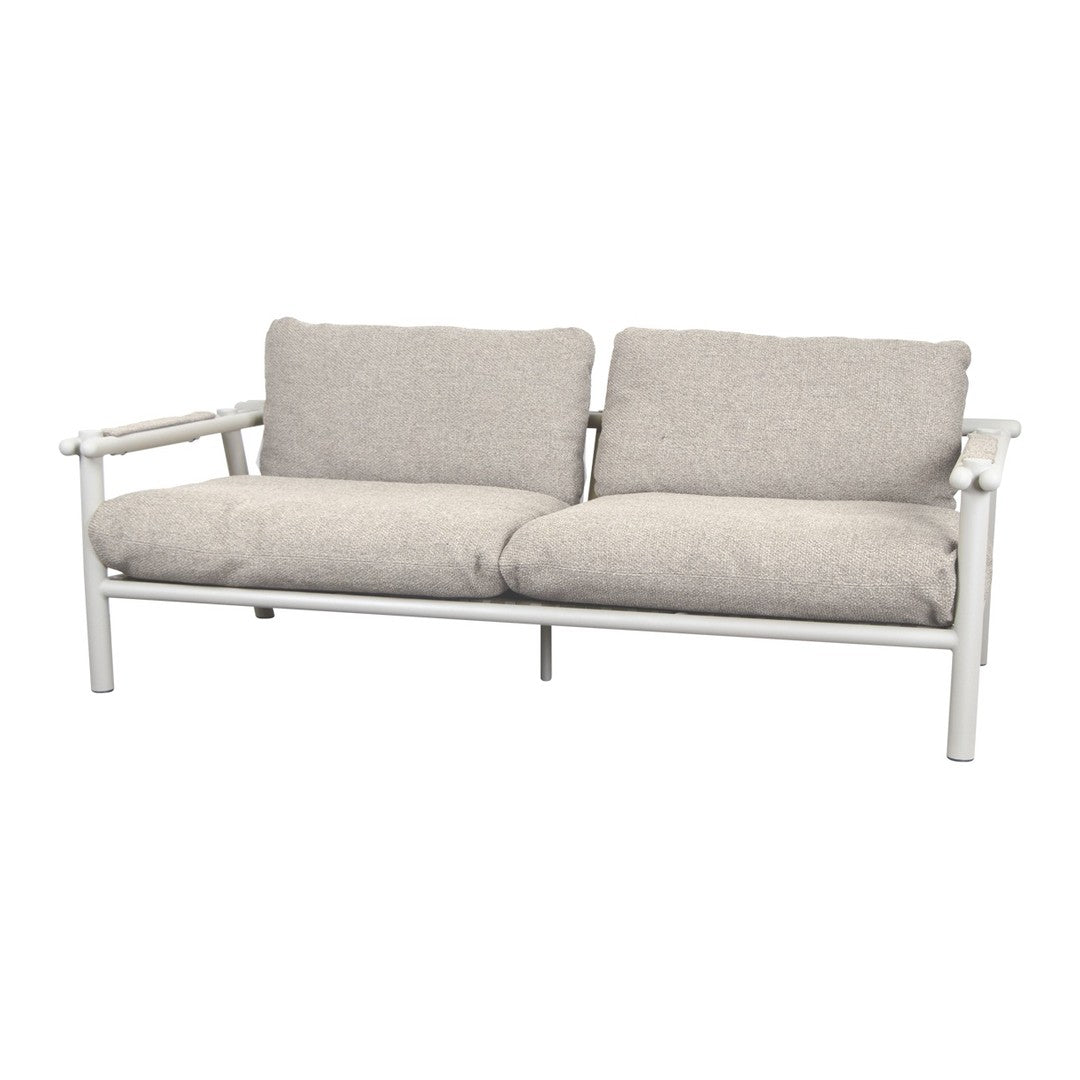 Light gray cushions on a white frame, featuring a soft, textured fabric for a modern, minimalist look.