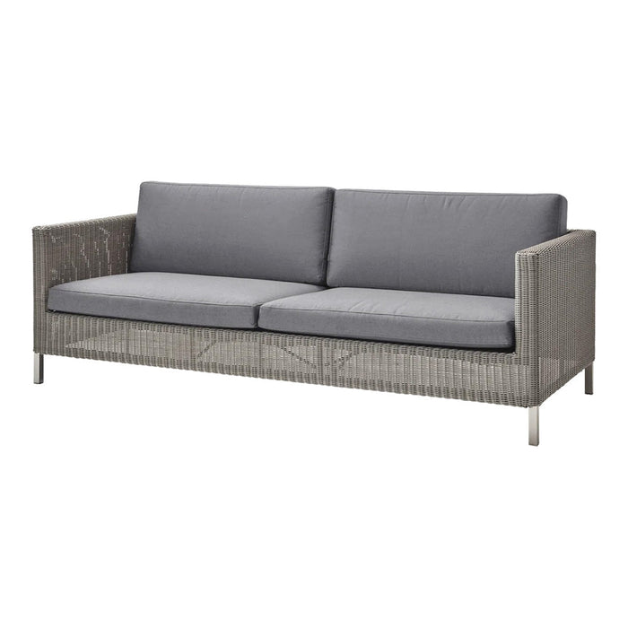 Gray wicker sofa with plush gray cushions and sleek metal legs, perfect for modern outdoor spaces.