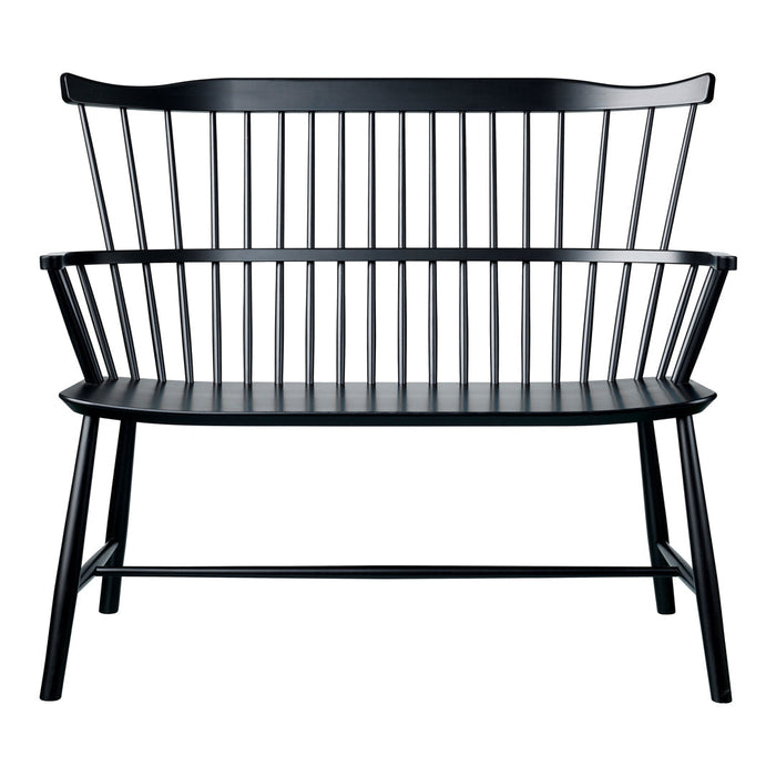 Black wooden bench with sleek vertical slats and a minimalist design, showcasing a modern, monochromatic aesthetic.