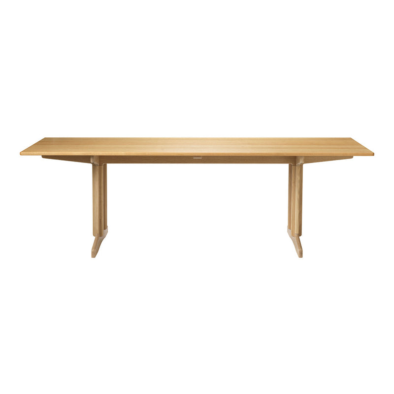 Light natural wood table with smooth surface and minimalist design, featuring tapered legs for a modern aesthetic.