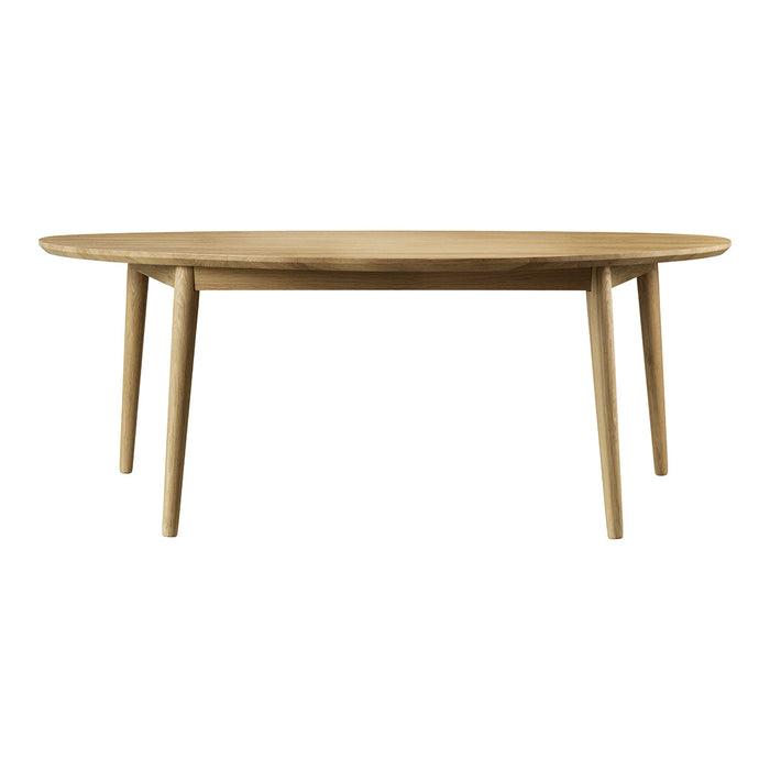 Oval wooden table in natural oak finish with smooth surface and light-colored legs. Perfect for modern dining spaces.