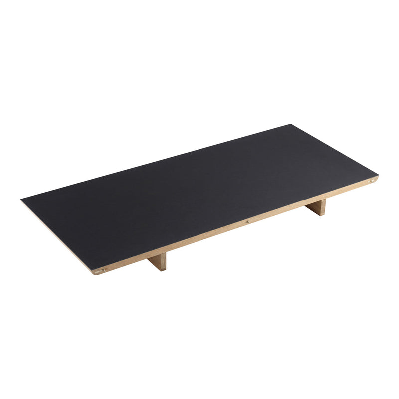Black rectangular tabletop with natural wood legs, minimalist design and smooth surface, ideal for modern decor.