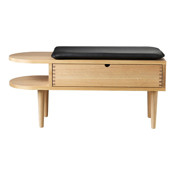 Light wood console table with a minimalist design, featuring a sleek black cushion and clean lines.