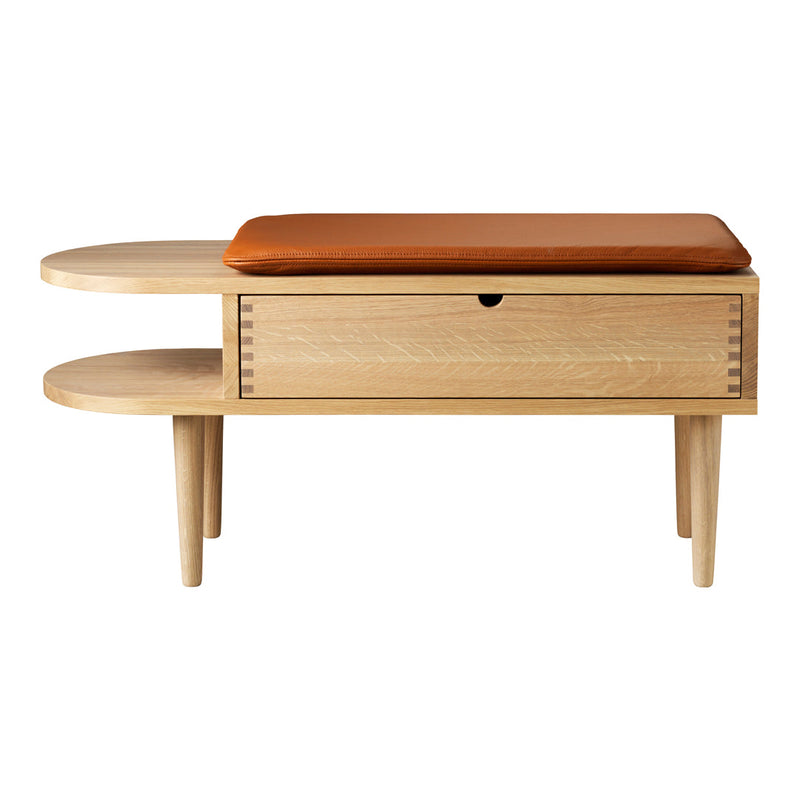 Light wood console table with a smooth surface, featuring a rich brown leather cushion and minimalistic design.
