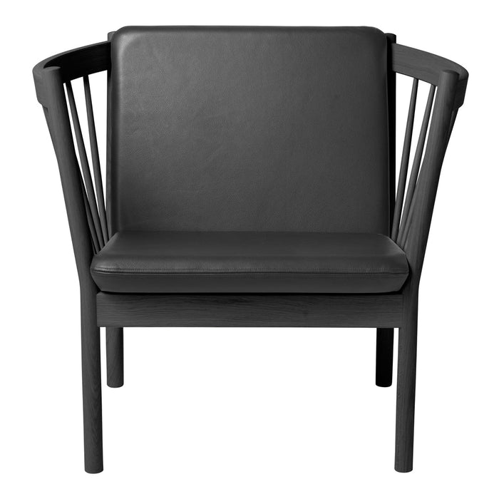Black modern chair with a sleek, minimalist design and geometric patterns in its backrest.