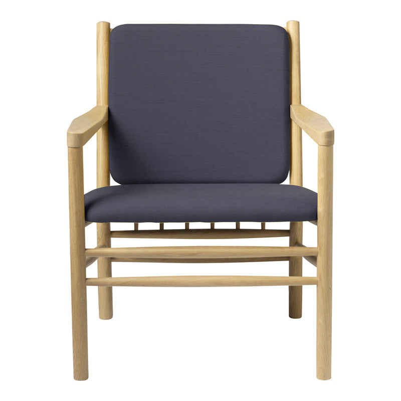 Modern wooden chair with a light natural finish and solid navy blue cushions. Simple, minimalist design.