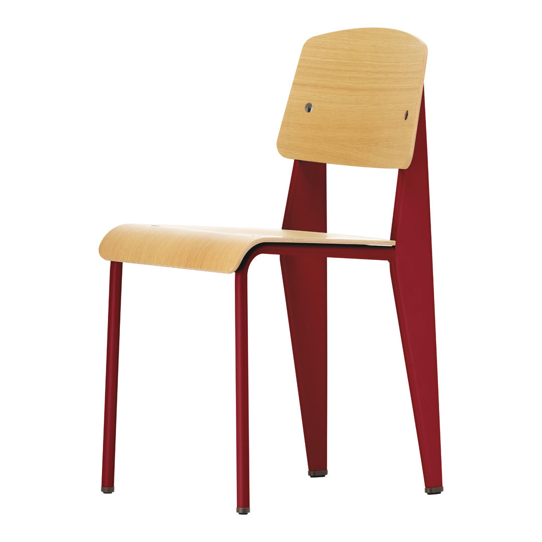 Wooden chair with a natural wood seat and back, contrasting red metal legs and supports, featuring a simple, modern design.