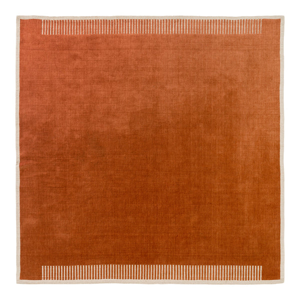 Rust-colored square rug with a subtle striped pattern along the edges.