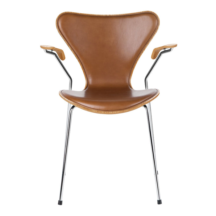 Brown patterned chair with sleek chrome legs and curved armrests, perfect for modern decor.