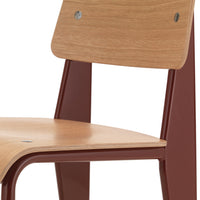 Wooden chair with a natural oak seat and rich burgundy metal legs, featuring simple lines and minimalistic design.