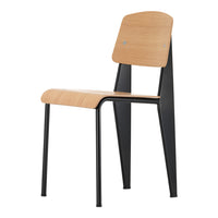 Modern wooden chair with a natural wood seat and backrest, featuring sleek black metal legs. Simple, stylish design.