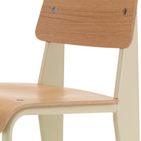 Light beige chair with a smooth, natural wood grain seat and backrest, showcasing a minimalist design.