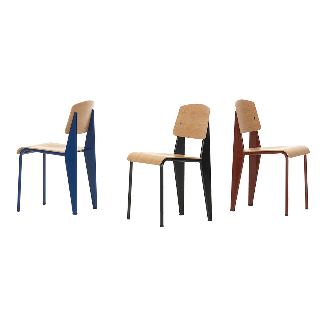 Set of three modern chairs in blue, black, and red with natural wood seats and minimalistic design.