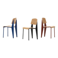 Set of three modern chairs in blue, black, and red with natural wood seats and minimalistic design.