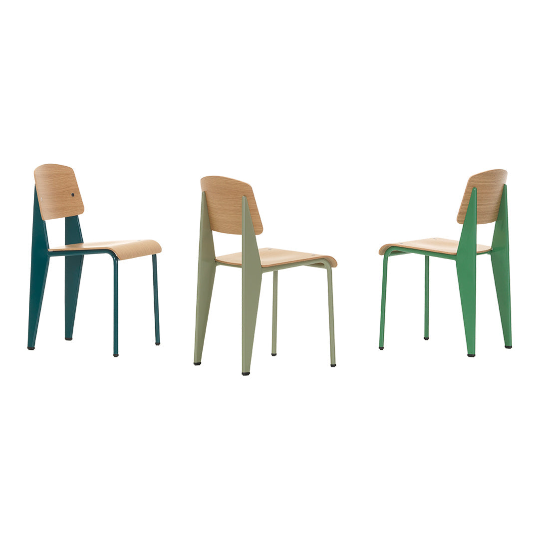Colorful modern chairs featuring a light wood seat and sleek, contrasting green and teal legs. Unique triangle design.