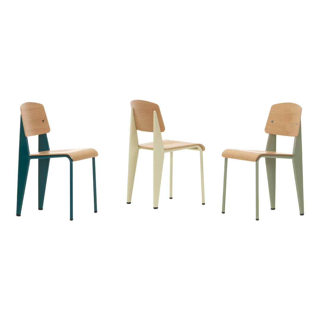 Three modern chairs featuring teal, light green, and soft beige colors with a minimalist design and smooth wood finish.