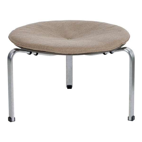 Round beige cushioned stool with a smooth fabric surface and metallic silver legs. Stylish and modern design.