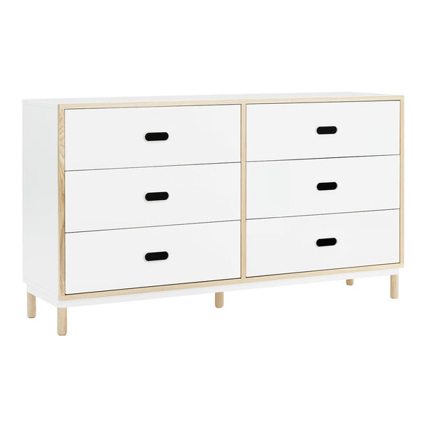 "White dresser with four drawers, gold accents, and black handles for a modern, minimalist look."