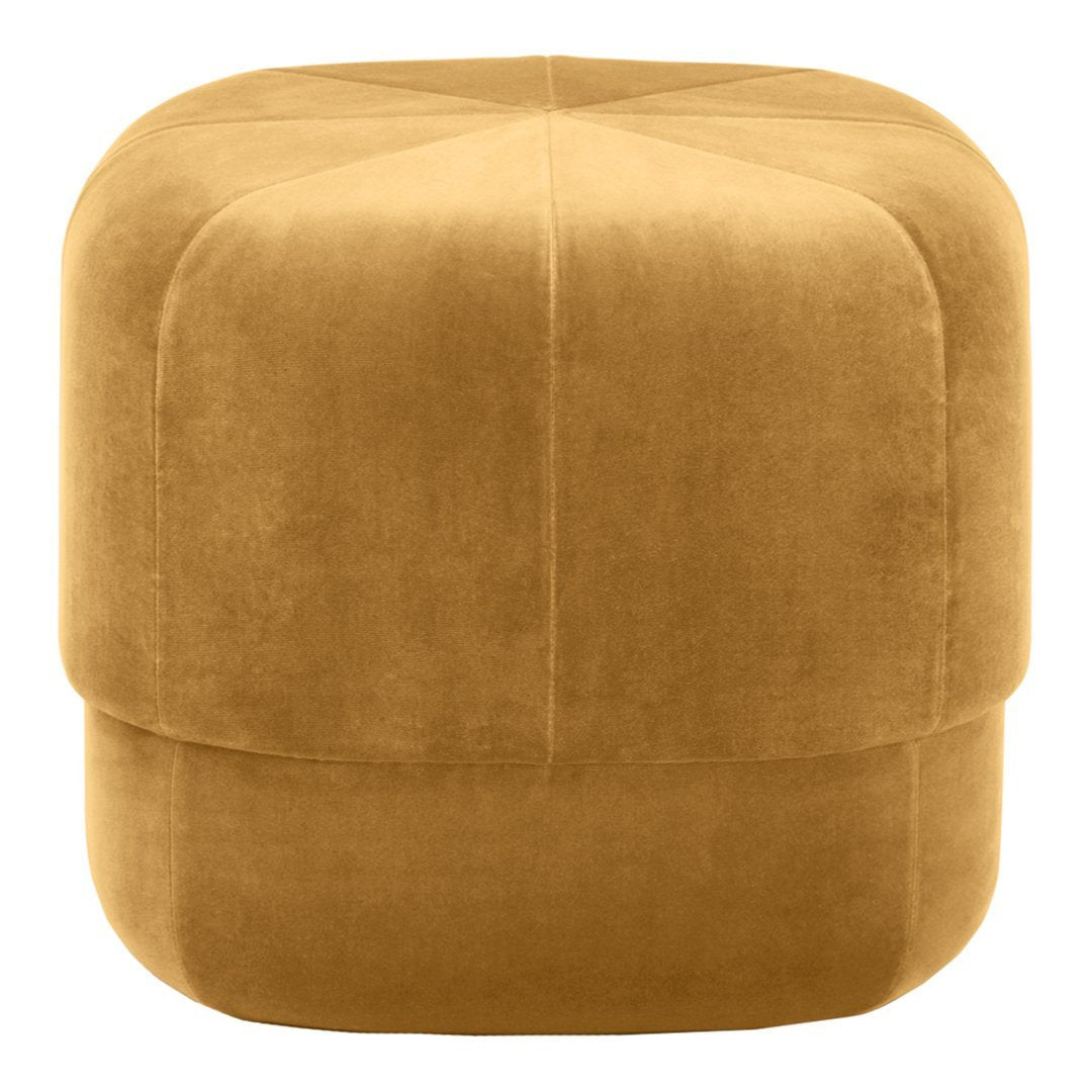 Soft golden yellow upholstered ottoman with a smooth, geometric design and subtle seam detailing.