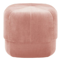 Soft pink velvet pouf with subtle diamond quilting pattern, perfect for modern decor.