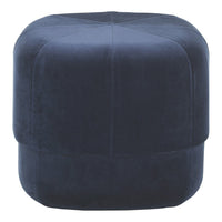 Navy blue velvet ottoman with a smooth, padded texture and geometric stitched pattern. Ideal for modern decor.