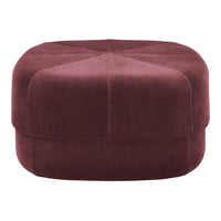 Plush burgundy ottoman with a hexagonal shape and quilted diamond pattern on top. Perfect for any modern decor.