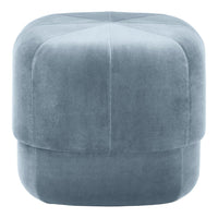 Soft blue velvet pouf with a smooth, textured surface and geometric pattern, perfect for modern decor.