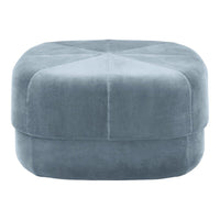 Soft blue upholstered ottoman with a smooth finish and subtle geometric pattern. Perfect for stylish home décor.