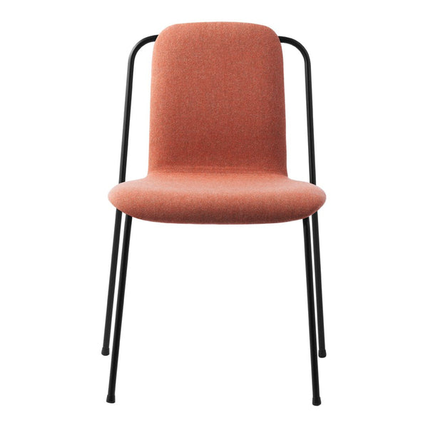 "Modern chair in soft terracotta fabric with sleek black metal legs and minimalist design."