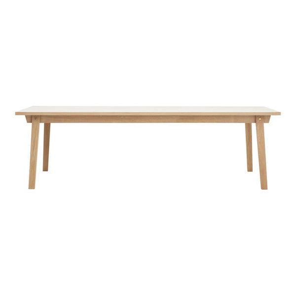 Light wood dining table with a smooth, natural finish and minimalist design, perfect for modern interiors.