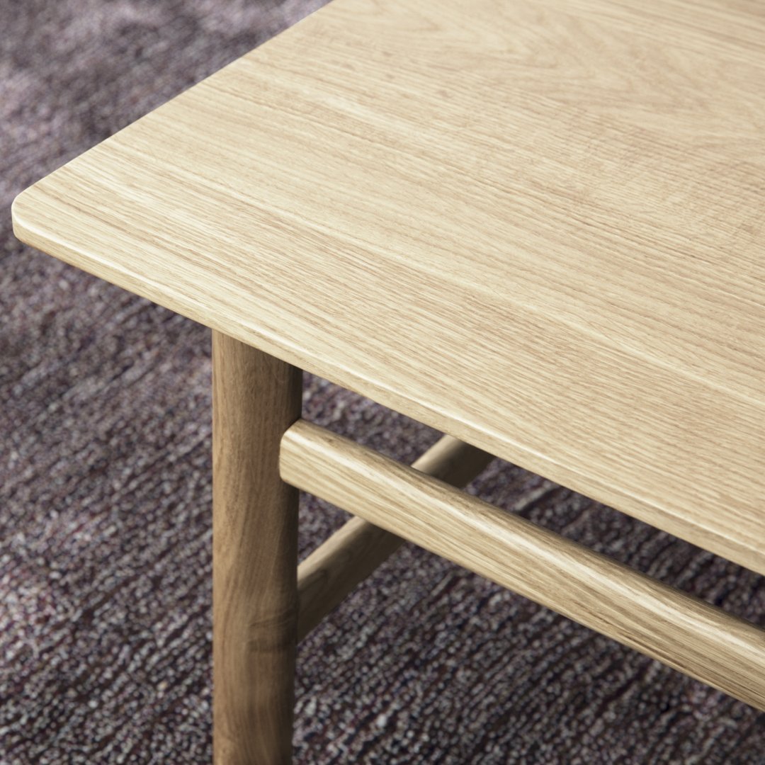 Natural oak wood table with a smooth, light finish, featuring a minimalist design and subtle grain pattern.