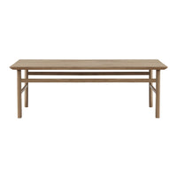Natural wood dining table in a light oak finish, featuring a simple, modern design with clean lines.