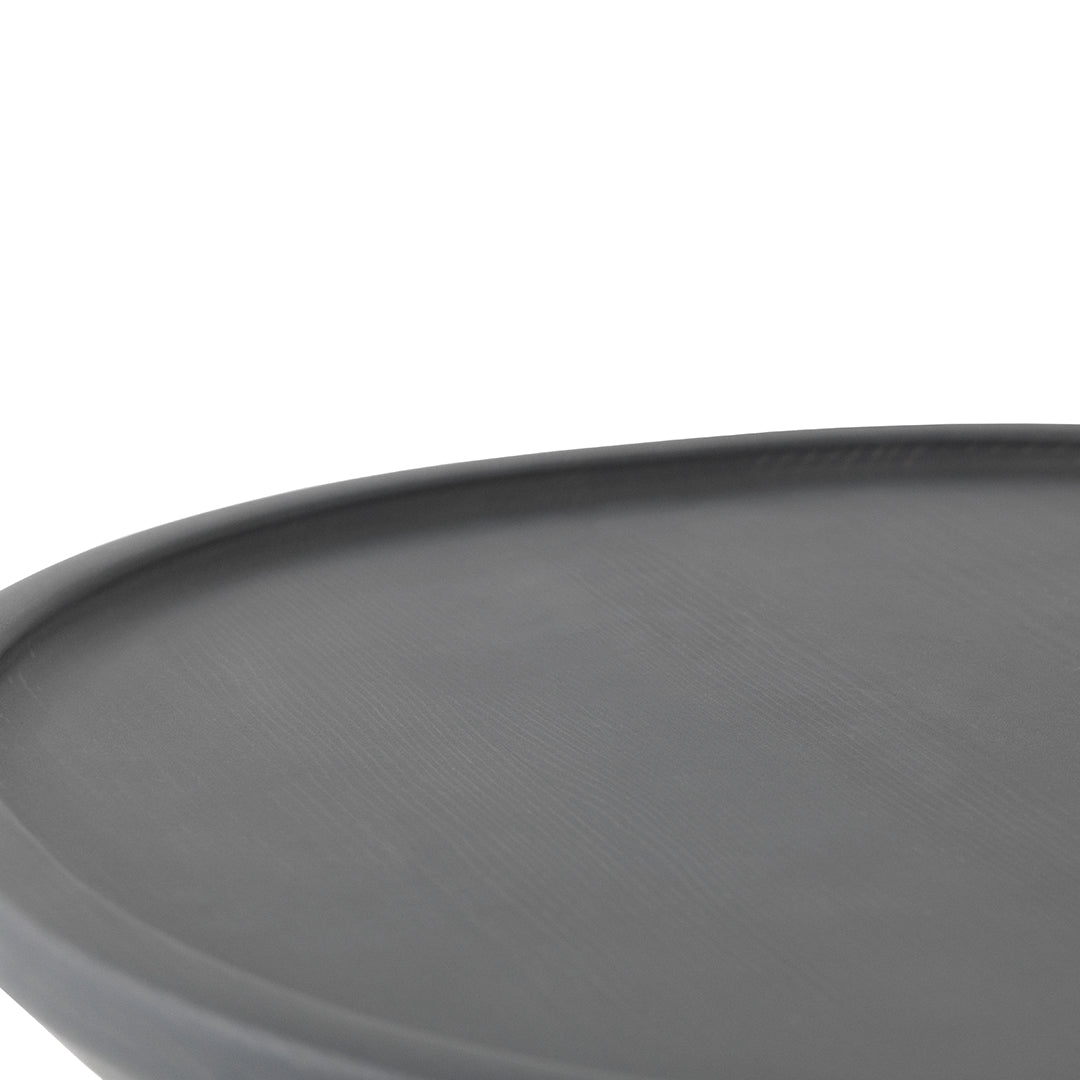 Round, matte black serving tray with a smooth surface and sleek, minimalist design. Perfect for modern decor.