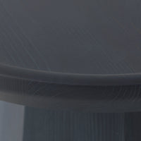 Close-up of a round table surface in dark gray with subtle wood grain pattern texture.