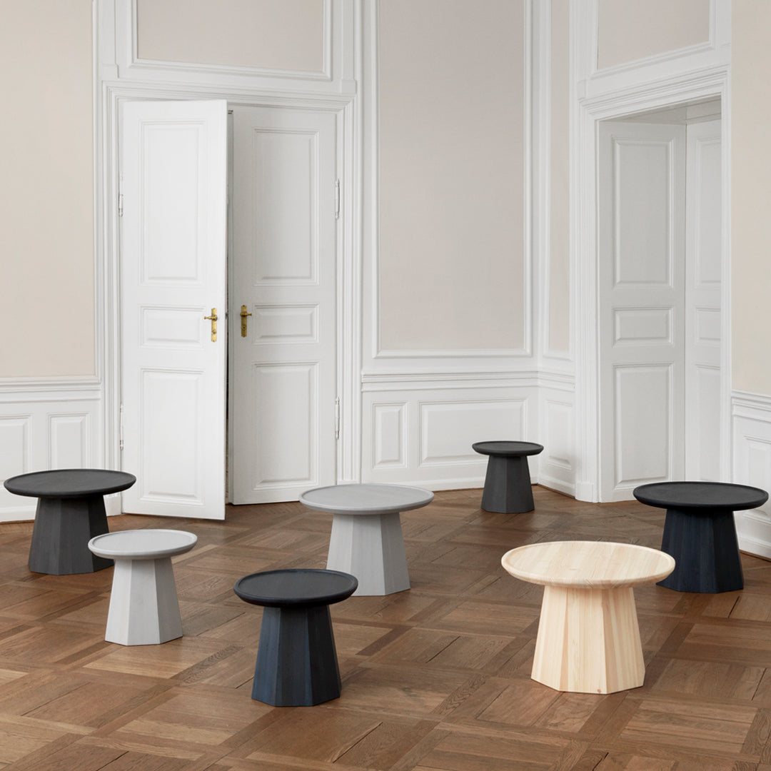 "Collection of modern tables in black, white, gray, and natural wood tones, featuring minimalist shapes and patterns."