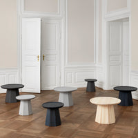 "Collection of modern tables in black, white, gray, and natural wood tones, featuring minimalist shapes and patterns."