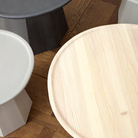 "Wooden and gray accent tables with smooth and textured surfaces, featuring minimalist designs and natural patterns."