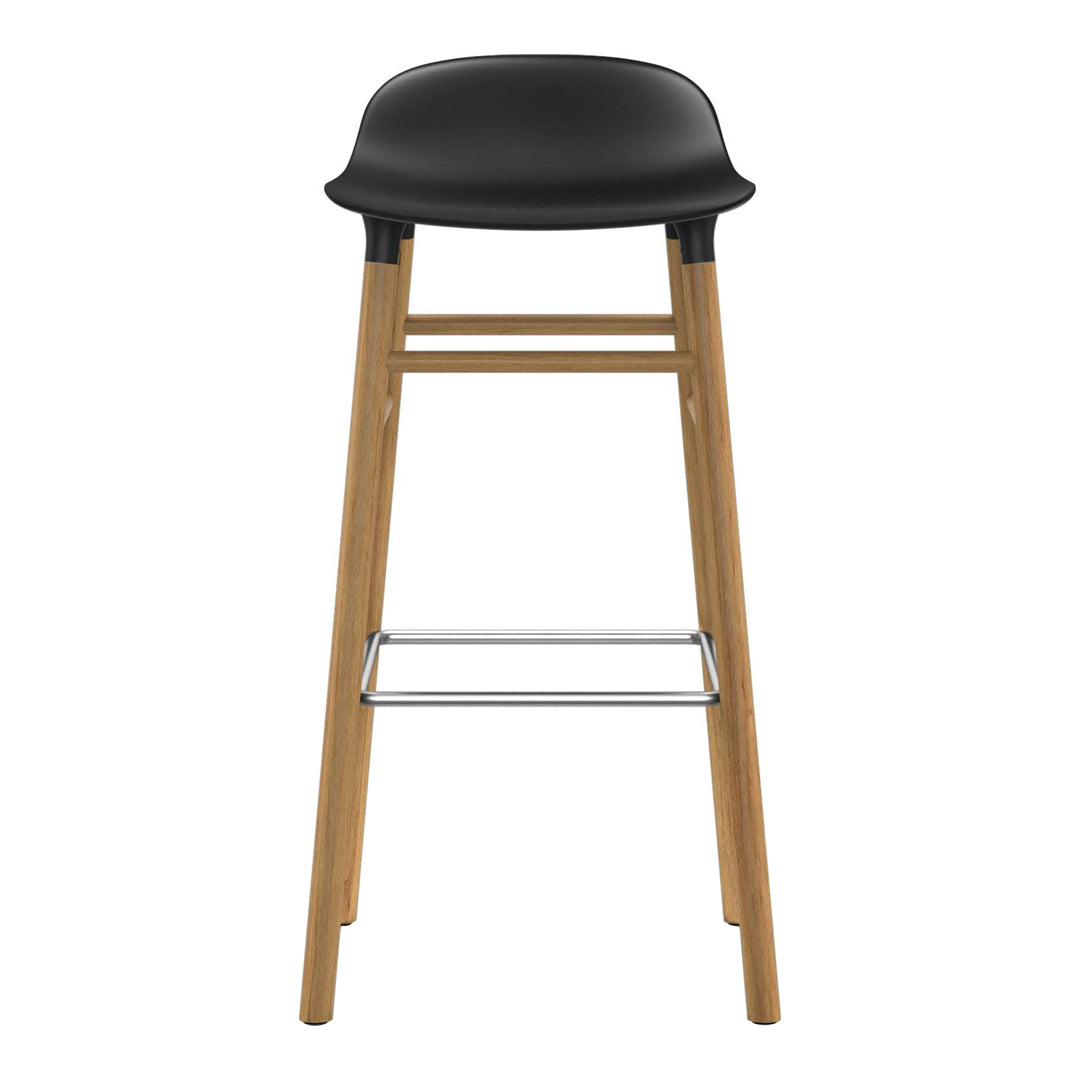 Black plastic seat with natural wood legs and chrome footrest, featuring a sleek, minimalist design.