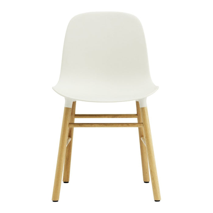 White modern chair with smooth surface and natural wood legs, perfect for minimalist decor.