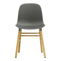 Stylish gray plastic chair with light wood legs, featuring a smooth, modern design. Perfect for contemporary spaces.