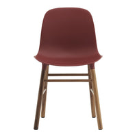 "Modern maroon chair with a smooth finish and natural wooden legs, perfect for contemporary decor."