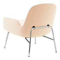 "Soft peach upholstery with chrome legs, featuring a sleek, minimalist design."