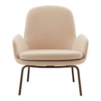 Soft beige armchair with smooth upholstery and minimalist design, accented by sleek metal legs. Perfect for modern decor.