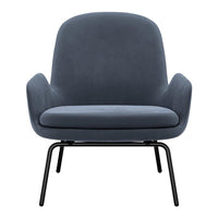Soft gray upholstered armchair with a smooth, minimalist design and black metal legs. Ideal for modern decor.