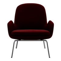 Burgundy velvet chair with sleek chrome legs, featuring a minimalist design and rounded silhouette.
