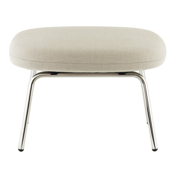Beige upholstered ottoman with a smooth texture and sleek chrome legs, featuring a minimalist design.